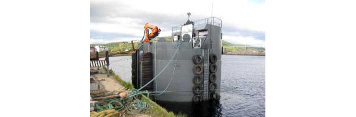 Docked feed barge before departure for the fish farm.